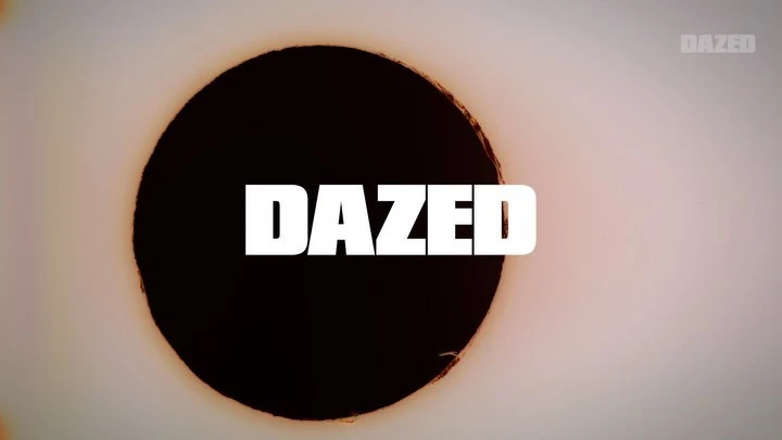 Abstract background with a large, dark circular shape in the center, featuring the white 'DAZED' text logo, set against a gradient backdrop.