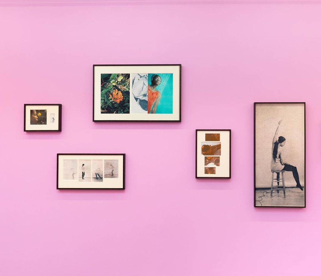 Gallery wall featuring five framed artworks arranged symmetrically on a light purple wall, creating a minimalist and contemporary art display.