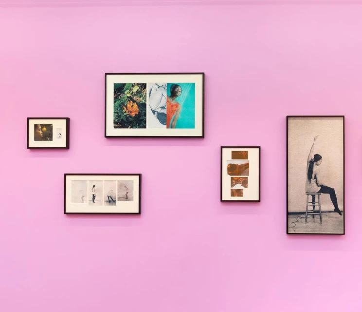 Gallery wall featuring five framed artworks arranged symmetrically on a light purple wall, creating a minimalist and contemporary art display.