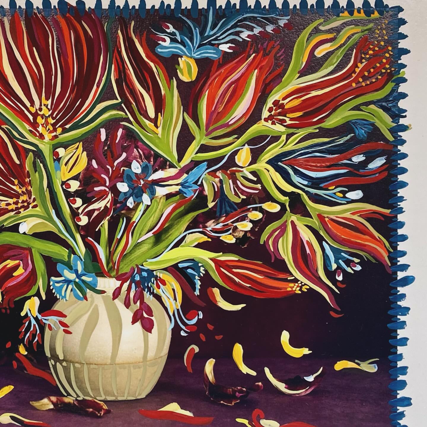 Painting of a floral arrangement in a beige vase with red, yellow, blue, and green painted flower blossoms and petals on a dark brown surface.