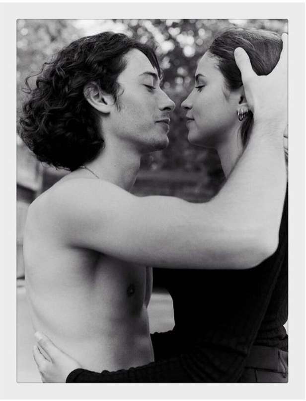 Black and white portrait of a man and woman embracing closely, shot by photographer Amit in Paris.