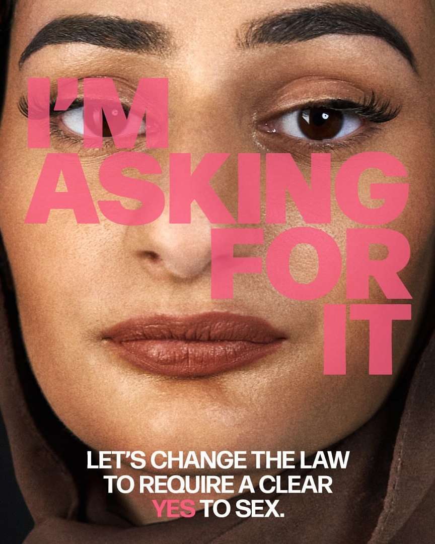 Close-up of a woman's face with brown eyes and light brown hijab with overlayed pink text, 'I'm Asking for It' and lower text, 'Yes to Sex'.