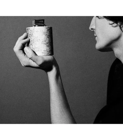 Monochrome portrait of a person holding a patterned cylindrical object in Paris, captured by Anastasiia Duvallie.