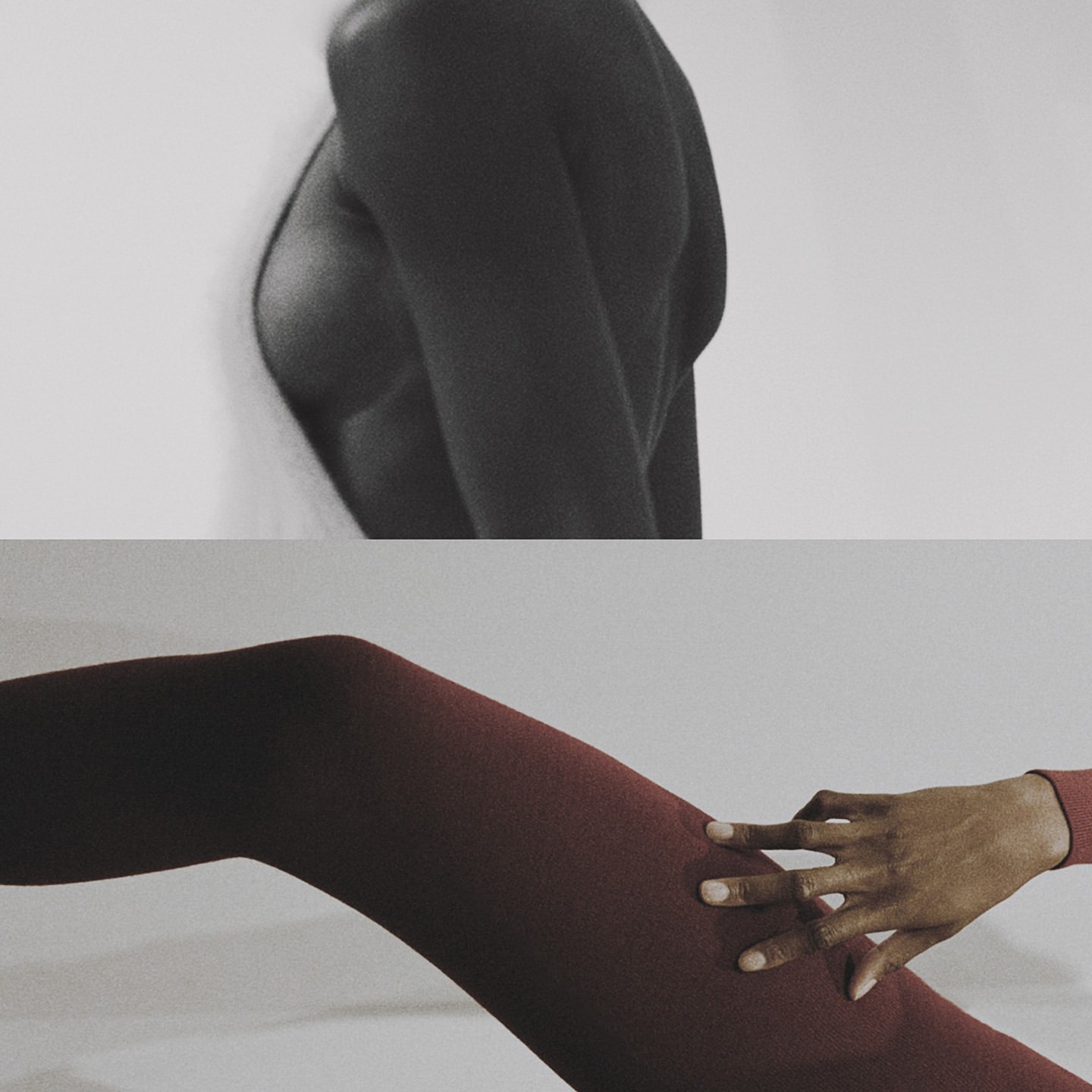 Artistic studio shot of a person's upper body in black and white and a person's leg in red bodysuit with their hand on their leg.