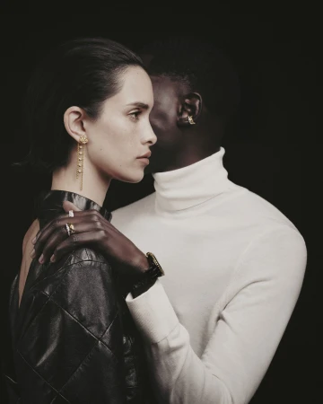 Close-up portrait of a woman in a black leather top and a man in a white turtleneck by Anastasiia Duvallie.