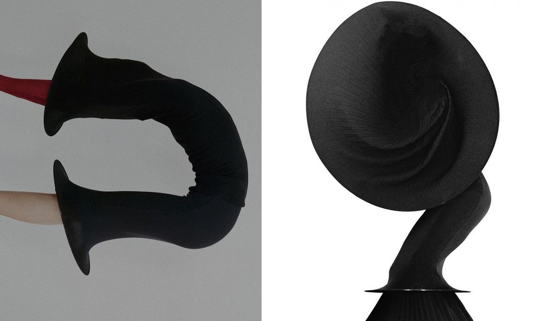 Abstract composition with two black forms, one elongated and the other rounded, against a white background, emphasizing shape and texture.