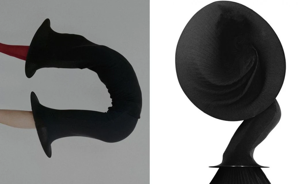 Abstract composition with two black forms, one elongated and the other rounded, against a white background, emphasizing shape and texture.