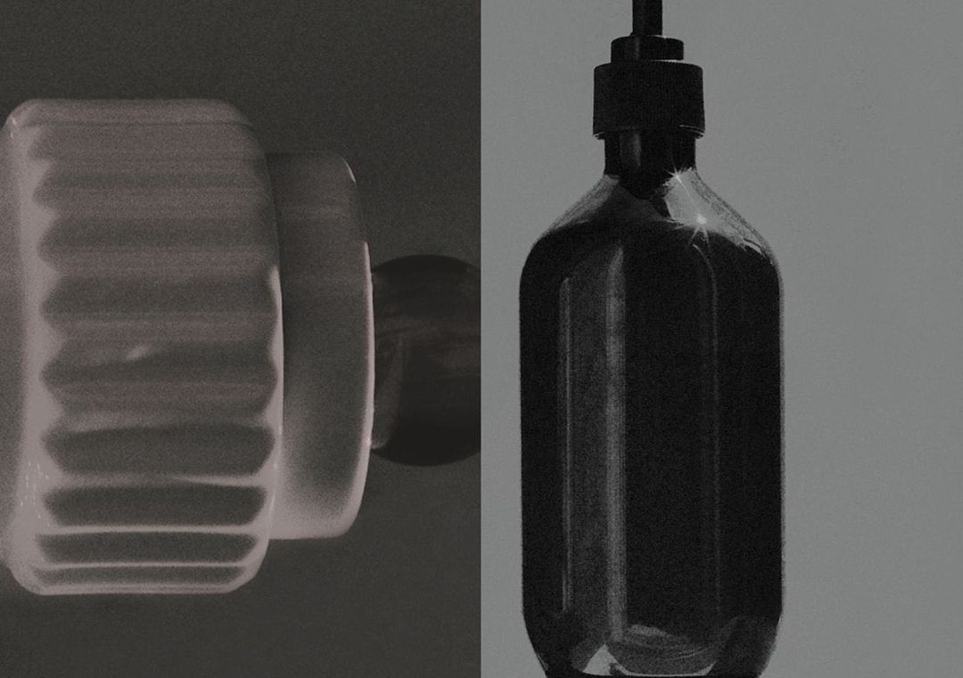 Elevated close-up showcases a ribbed white porcelain soap dish alongside a sleek black pump bottle, set against a muted gray backdrop.