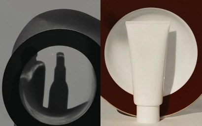 Split view showing a minimalist white cosmetic tube against a plate on the right, and a silhouetted bottle inside a circular shadow on the left.
