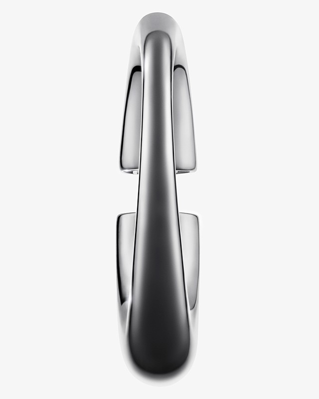 Close-up studio shot of a sleek, modern metal water faucet with a curved spout and reflective surface, set against a plain white background.