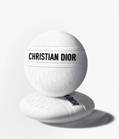 Two white Christian Dior skincare containers stacked on each other against a bright white background with a shadow beneath. Beauty shot.
