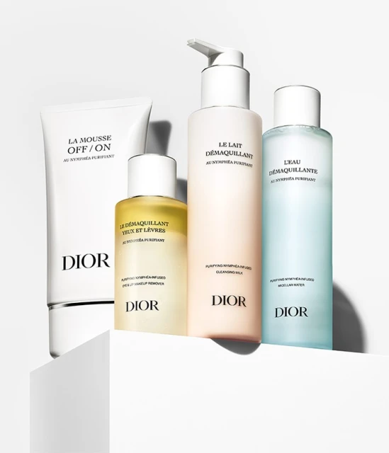Dior skincare product lineup featuring cleanser, eye and lip makeup remover, cleansing milk, and micellar water on white platform.