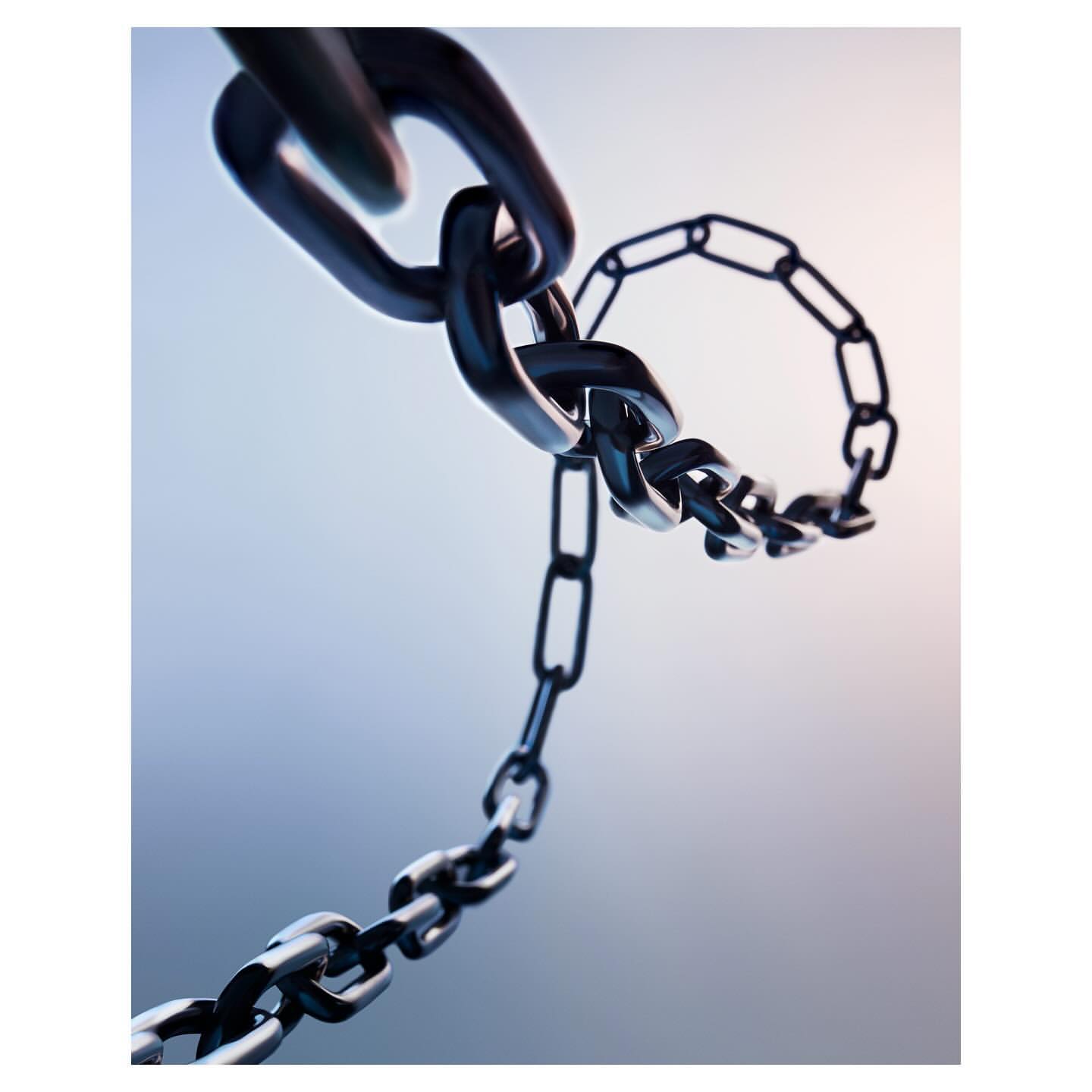 Abstract macro photograph of a curved, interlinked metal chain against a gradient blue and white background. Conceptual, strength, security theme.