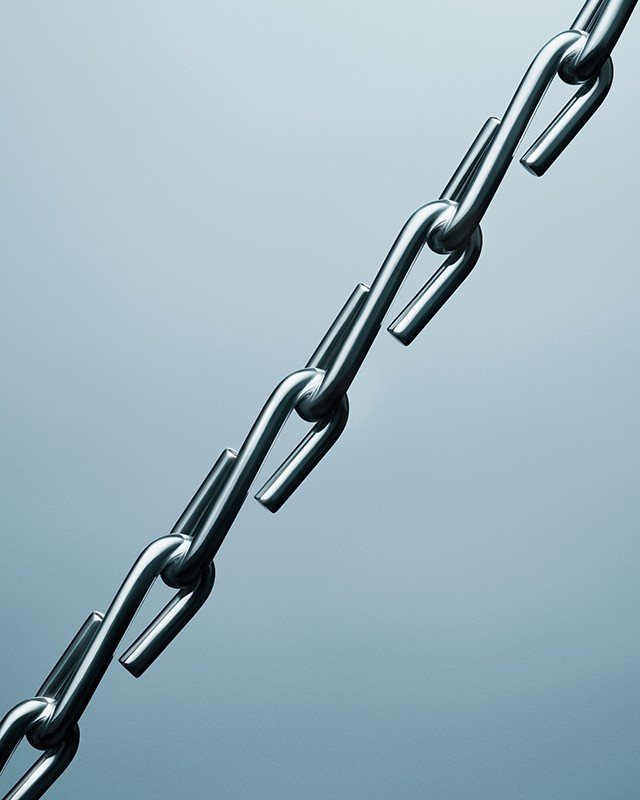 Close-up of a shiny metal chain against a gradient blue background, showcasing the industrial design and interconnected links.