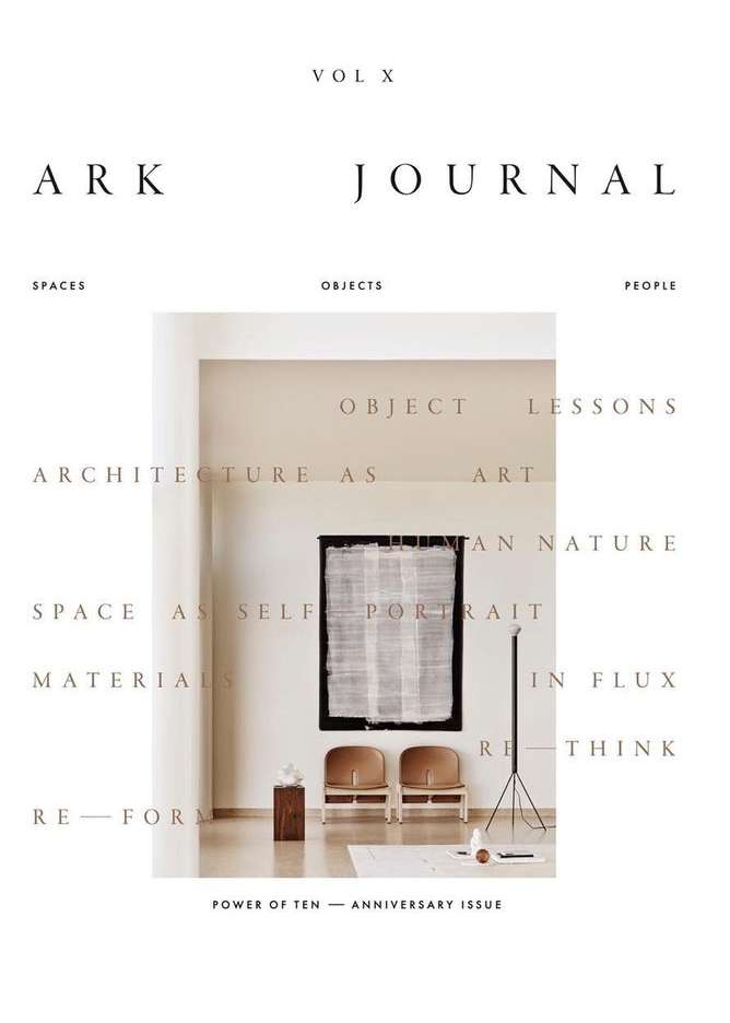 ARK Journal Volume X cover featuring an architectural interior with two chairs, a wooden plinth, artwork, and stark white walls.