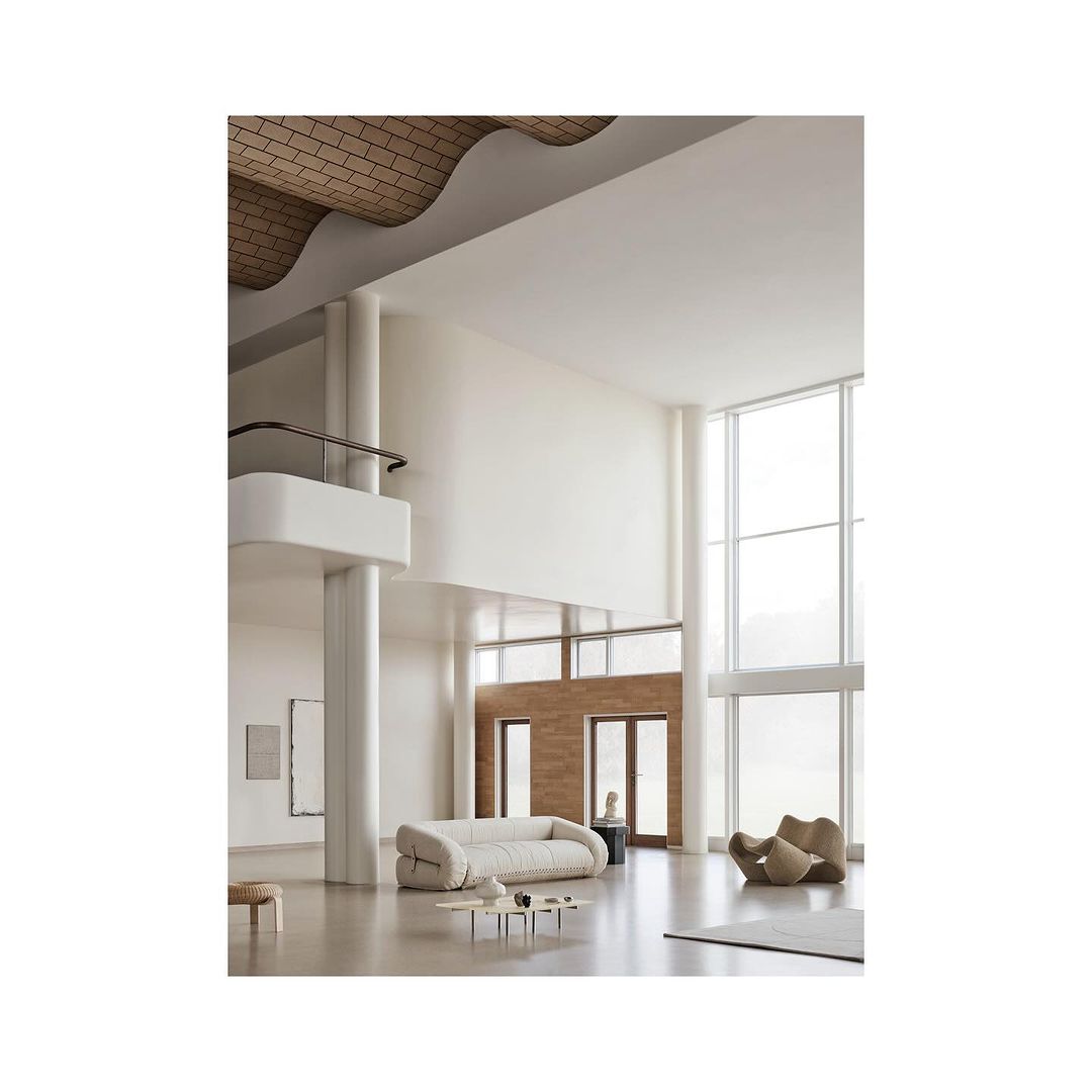 Minimalist interior design showcases a spacious living room with a cream-colored sofa, unique armchair, large windows, and high ceilings.