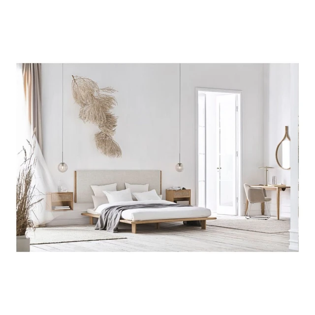 Minimalist bedroom features a platform bed with white linens, bedside tables with lamps, and neutral decor, creating a serene atmosphere.