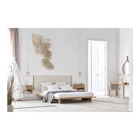 Minimalist bedroom features a platform bed with white linens, bedside tables with lamps, and neutral decor, creating a serene atmosphere.