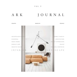 Minimalist interior with a low tan leather sectional sofa, white wood floor, and black pendant light by photographer Anders Schonnemann