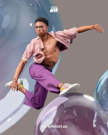 Young Black male model in glasses leaps over purple bubble, wearing casual pink top and lilac pants, for eyeglasses advertisement.