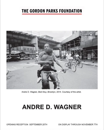 Black and white photograph captures a man on a bicycle holding a child, with other cyclists and urban Brooklyn street scene visible.