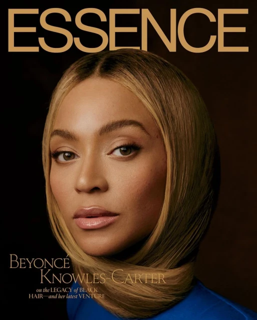 Essence magazine cover featuring a close-up portrait of Beyoncé Knowles-Carter with blonde hair and wearing a blue top against a brown background.