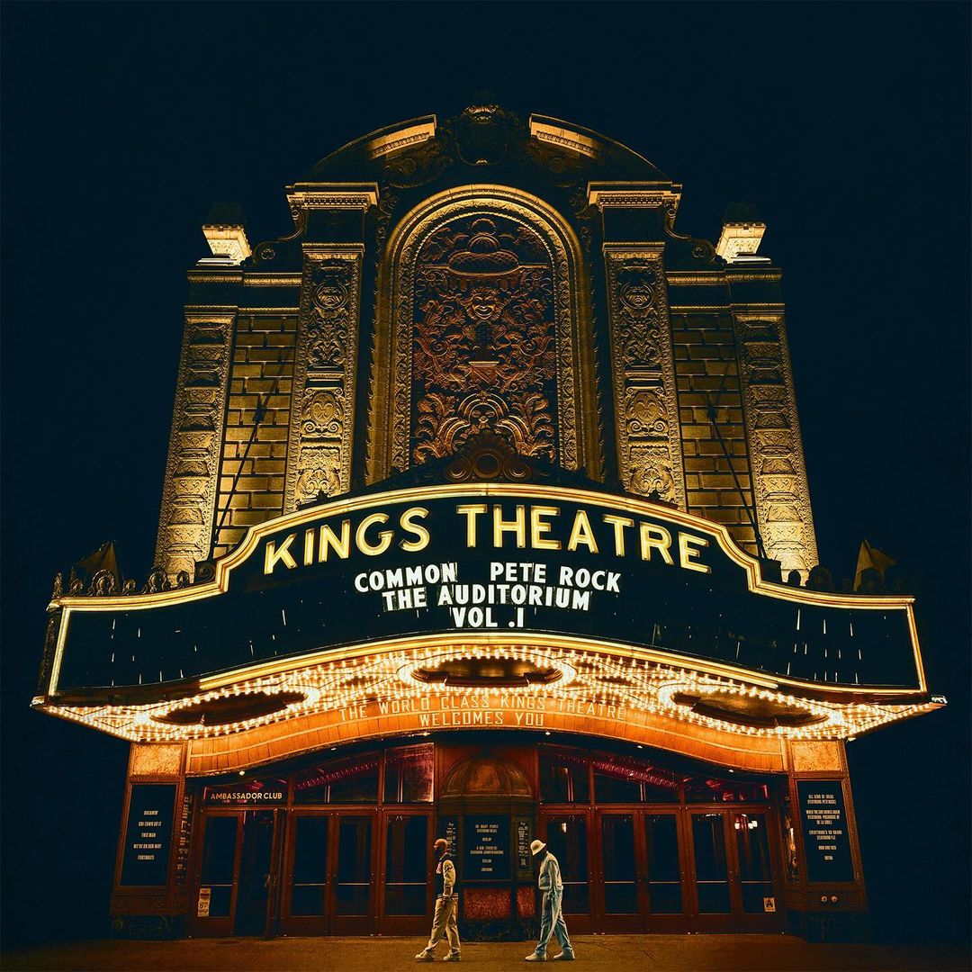 Kings Theatre illuminated at night, featuring people walking toward the entrance under the bright marquee lights in an urban environment.