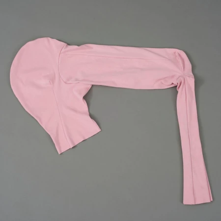 Flat lay of a one-sleeved, pink spandex or nylon garment on a grey background. Fashionable and form-fitting apparel for women.