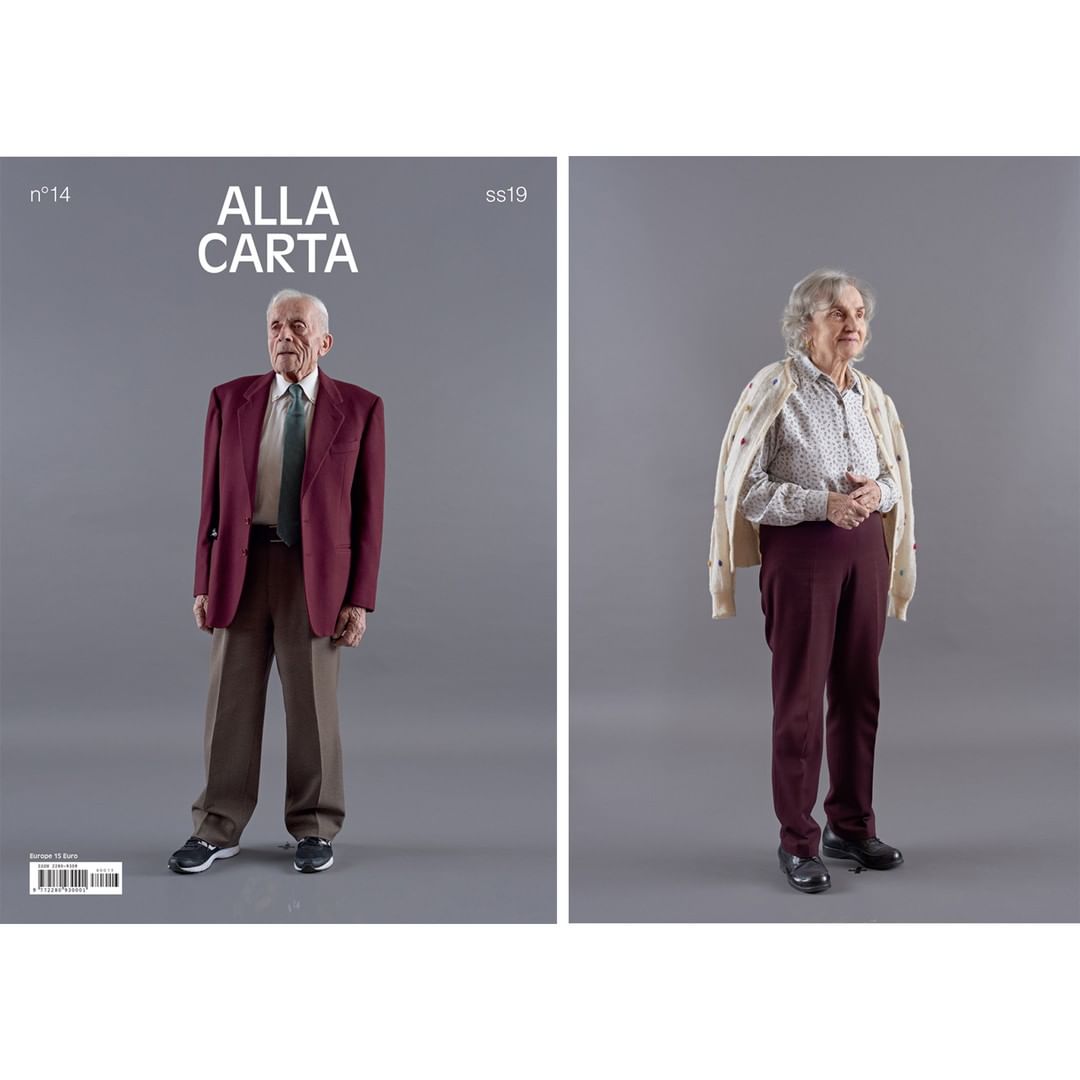 Fashion magazine cover featuring an elderly man in a burgundy suit and an elderly woman with a beige cardigan on a gray background.