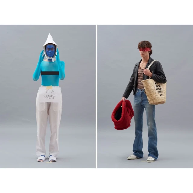 Two models pose in a photo studio against a grey backdrop: one in Smurf-like blue body paint and one in 70s-inspired fashion.