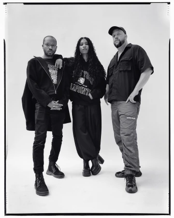 Portrait of three people standing against a white backdrop, photographed by Andreas Laszlo Konrath in New York.