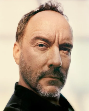 Close-up portrait of a middle-aged man with short thinning hair, a trimmed grey beard, and a serious expression.