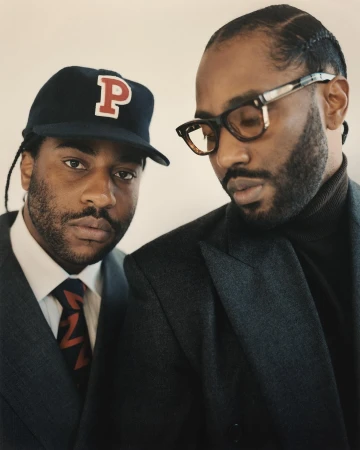 Portrait of two Black men in tailored suits and eyewear photographed by Andreas Laszlo Konrath in New York