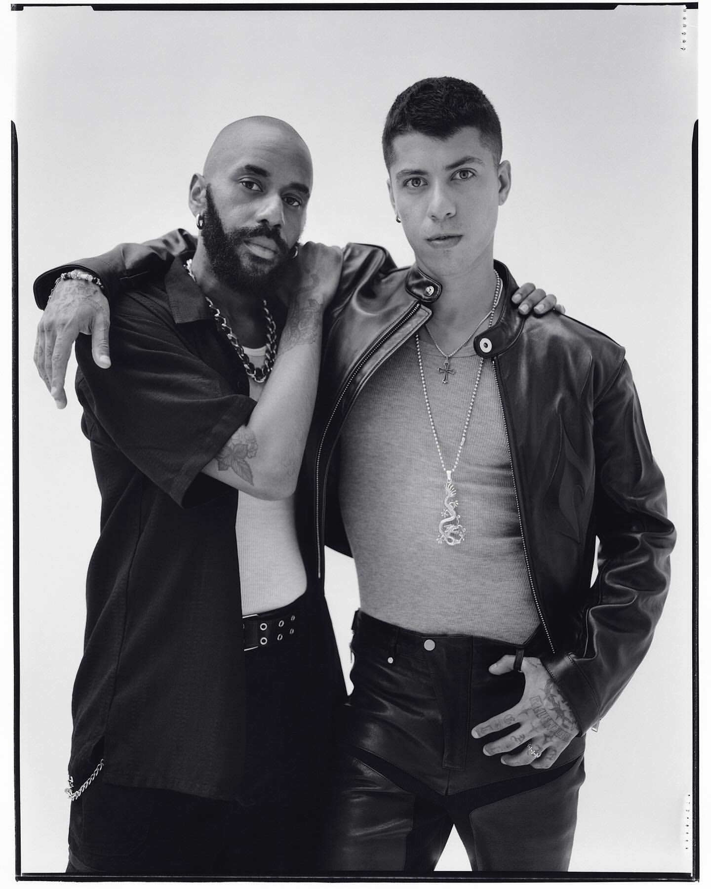 Portrait of two men posing together against a plain white seamless studio background in New York by Andreas Laszlo Konrath.