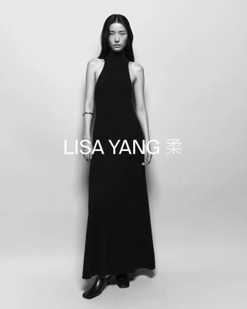 Black and white portrait of a woman in a black turtleneck dress, posing in a photo studio with the text LISA YANG overlaid.