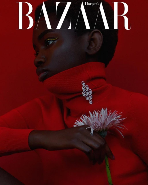 Fashion magazine cover featuring a Black woman in a red turtleneck sweater, holding a daisy, with 'BAZAAR' text overlay.