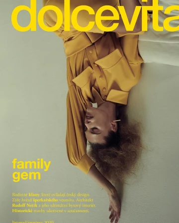 Magazine cover featuring a woman in a yellow outfit with text "dolcevita family gem". The model is upside down against a neutral background.