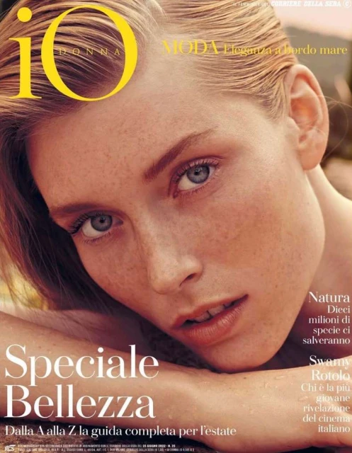 Fashion magazine cover featuring a close-up of a young woman with freckles and reddish-blonde hair looking at the camera with soft, natural lighting.
