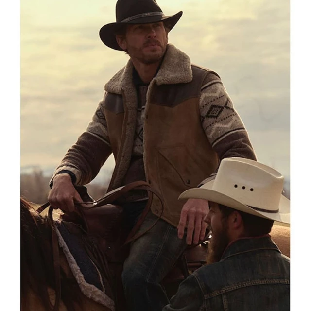 Two men on horseback, one wearing a black cowboy hat and a sheepskin vest, the other a white cowboy hat, in an outdoor setting.