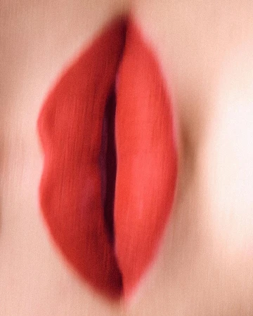 Extreme close-up macro portrait of red lips with smooth matte texture by Andreas Ortner.