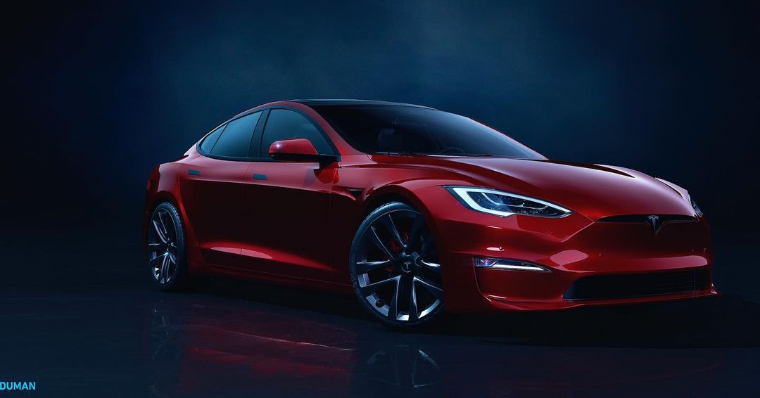 Red Tesla Model S electric car on a dark reflective surface, showcasing its sleek design and modern features in a studio setting.