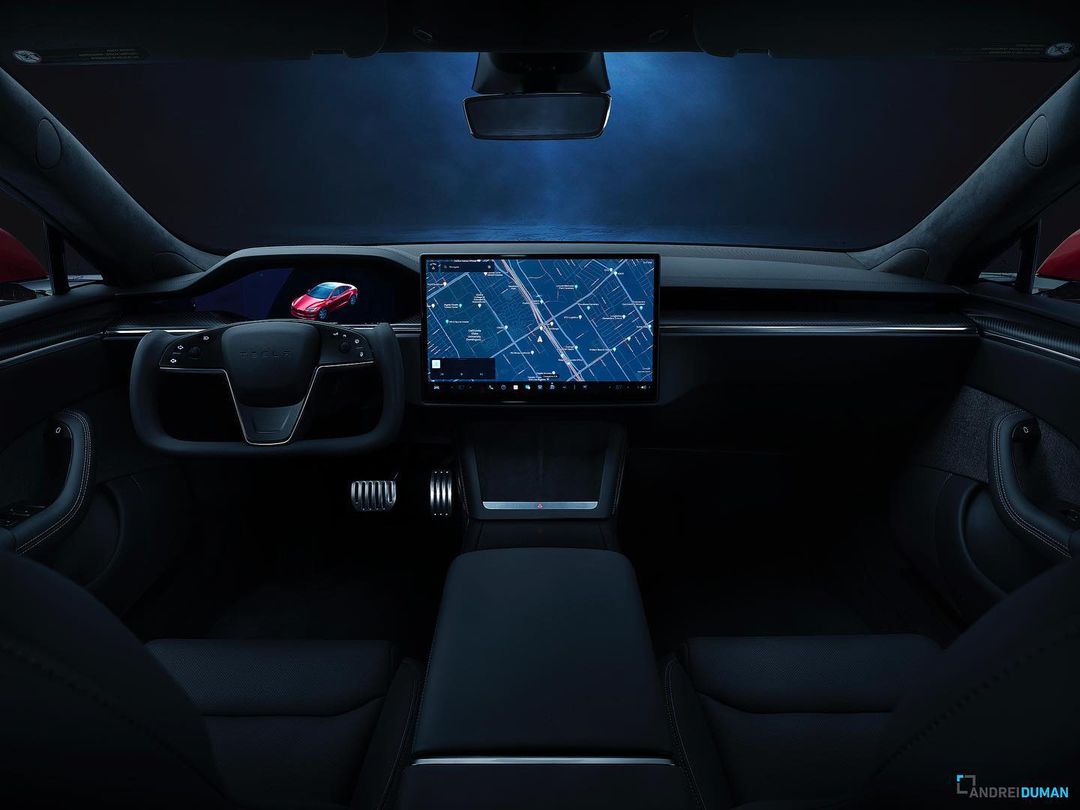 Interior of a black Tesla with a digital display showing a red car, capturing sleek design and modern automotive technology.