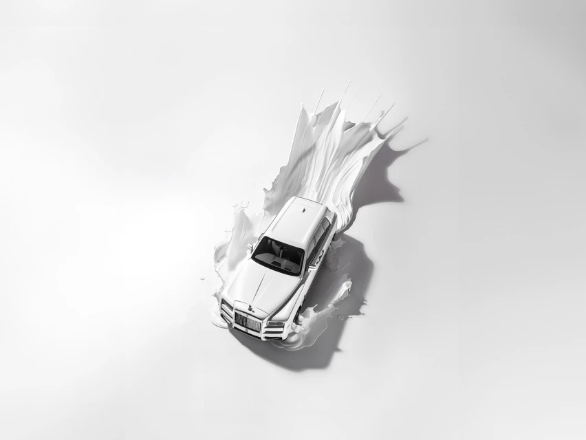 Elevated shot of a white Rolls Royce car partially submerged in a splash of white paint against a bright white background.