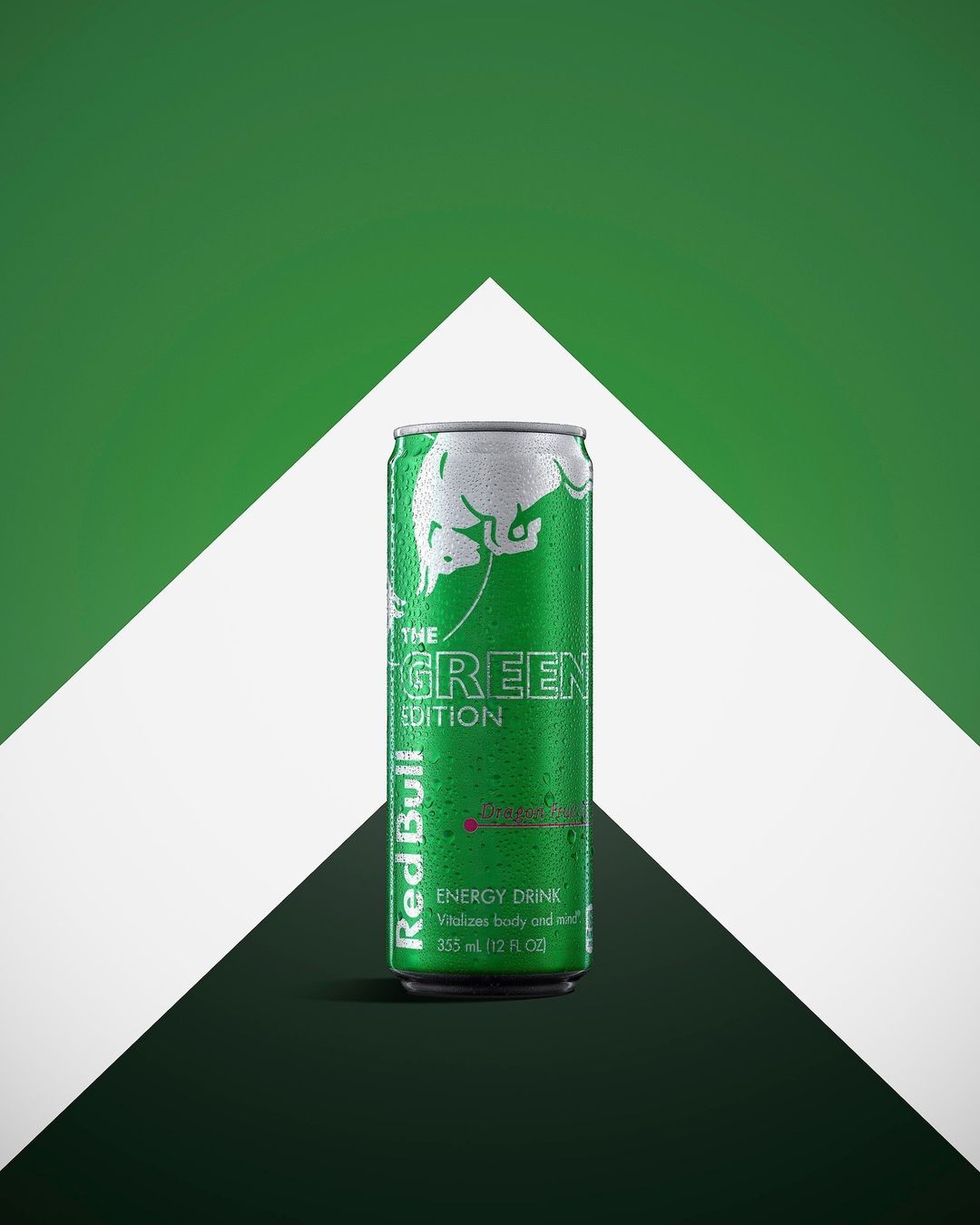 A vibrant, studio shot of a green 'The Green Edition' Red Bull can, set against a modern geometric background of white and green.