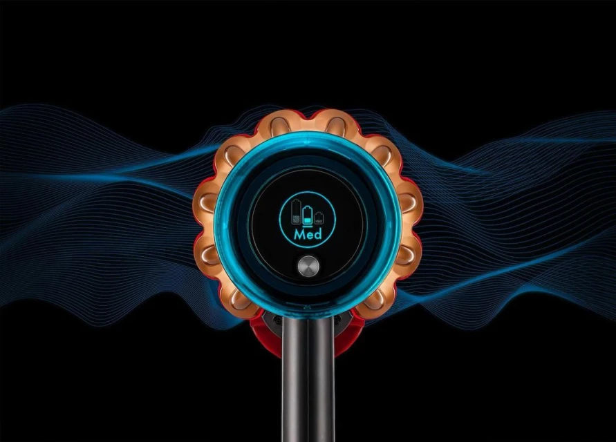 Close-up of a Dyson vacuum cleaner with a digital display showing the medium setting, set against a black background with blue waves.