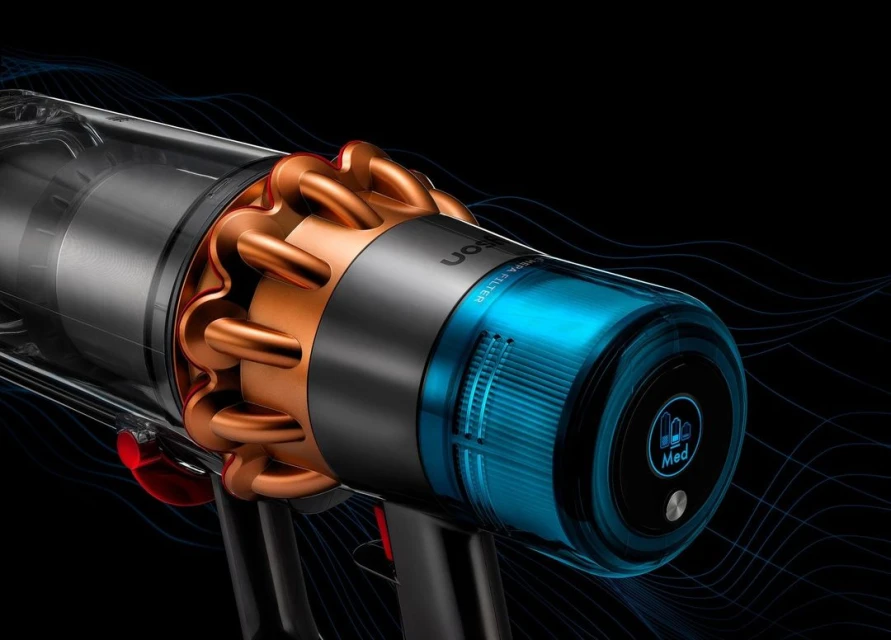 Close-up studio shot of a Dyson vacuum cleaner, showcasing its cyclone technology, translucent dustbin, and sleek design on a black backdrop.