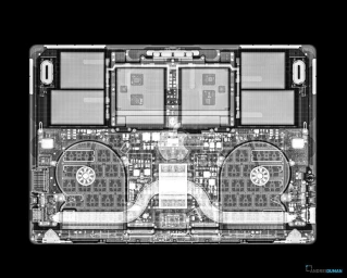 X-ray view of laptop interior showing circuit boards, dual cooling fans, and internal components against a black background.