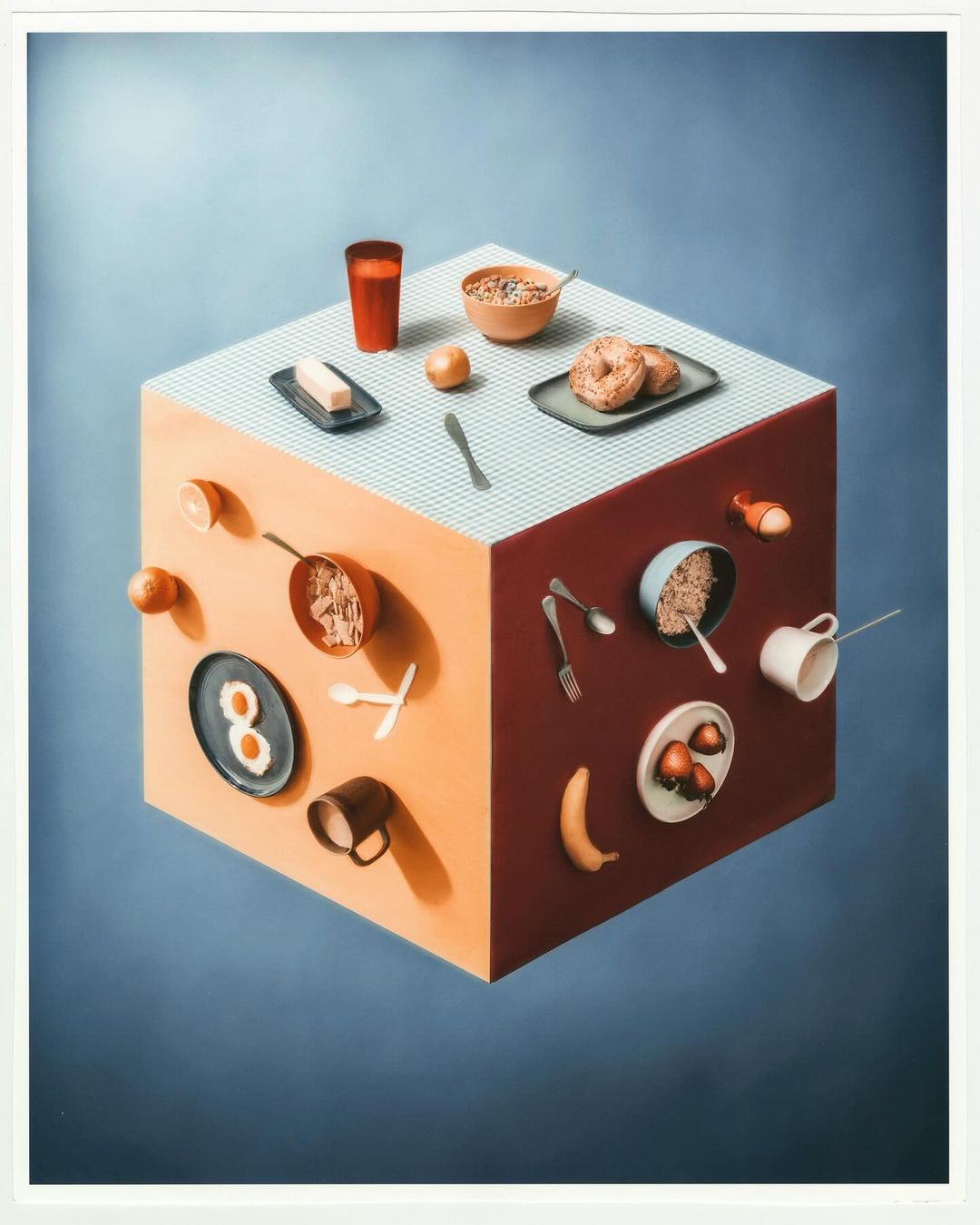 Illustration of a 3D cube with breakfast foods and dining utensils levitating around its sides, set against a blue gradient background.