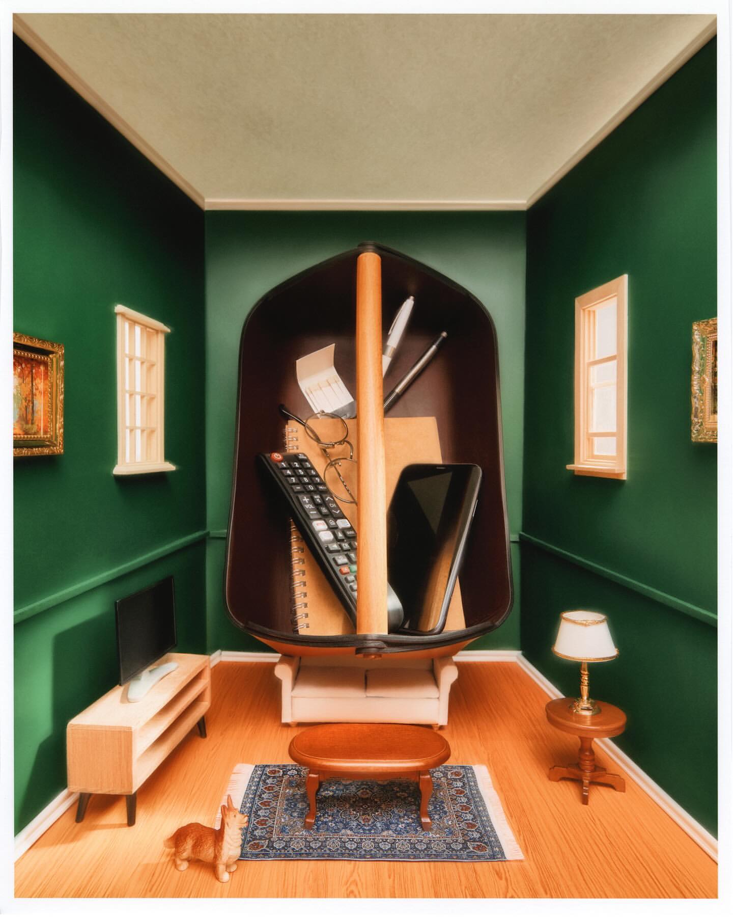 Interior scene featuring a small dog near a coffee table with a boat filled with a phone, remote, and glasses, set against green walls.