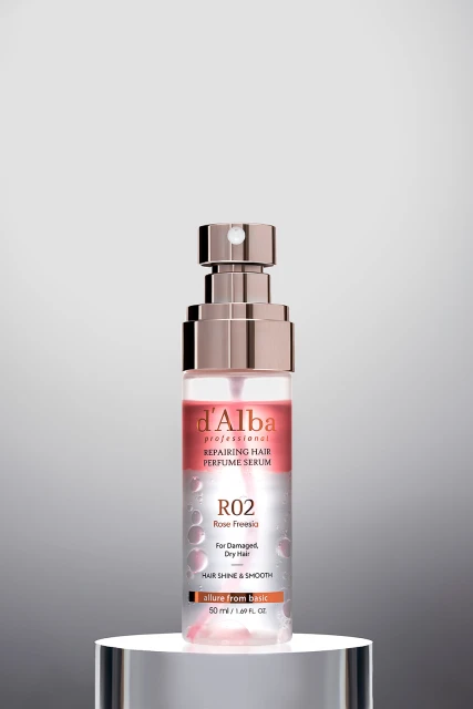 D'Alba Professional Repairing Hair Perfume Serum R02, against a gradient gray background on a white cylindrical display base.